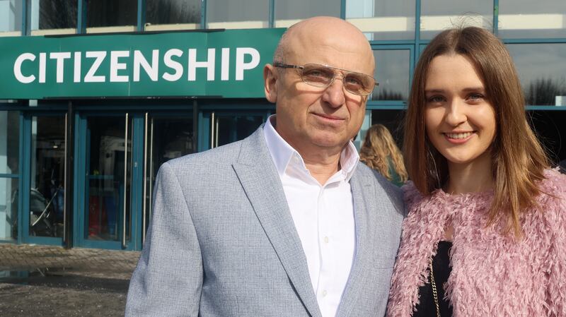 Father and daughter Bakuri and Ekaterina Rajuli, originally from Georgia, celebrate getting their Irish citizenship at the RDS on Friday. Photograph: Ronan McGreevy