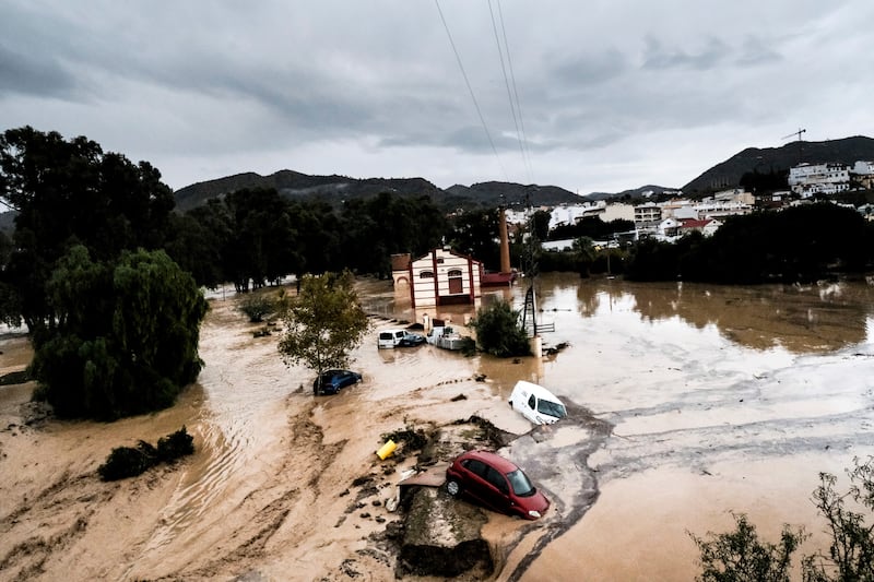 Cars are swept away by the water after floods preceded by heavy rains caused the river to overflow its banks in the town of Alora, Malaga Photograph: Gregorio Marrero/AP