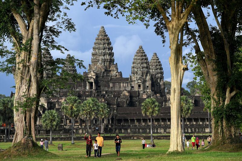 People walk around Angkor Wat temple in Siem Reap province on July 5, 2022. (Photo by TANG CHHIN SOTHY / AFP) (Photo by TANG CHHIN SOTHY/AFP via Getty Images)