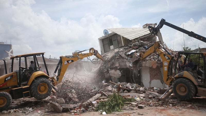 A damaged house is torn down in Jojutla de Juarez.