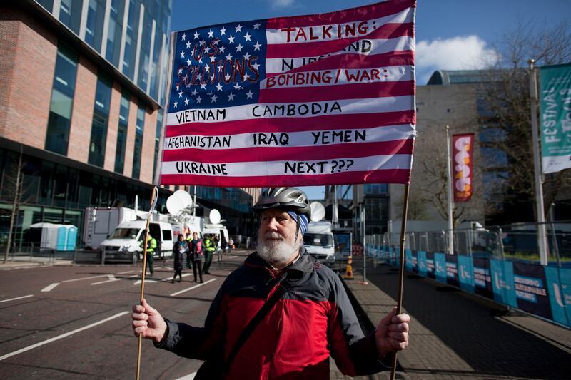 A protester holds a US flag outside the Ulster University's new Belfast campus ahead of a visit by the US president. Photograph: Thomas McMullan/EPA