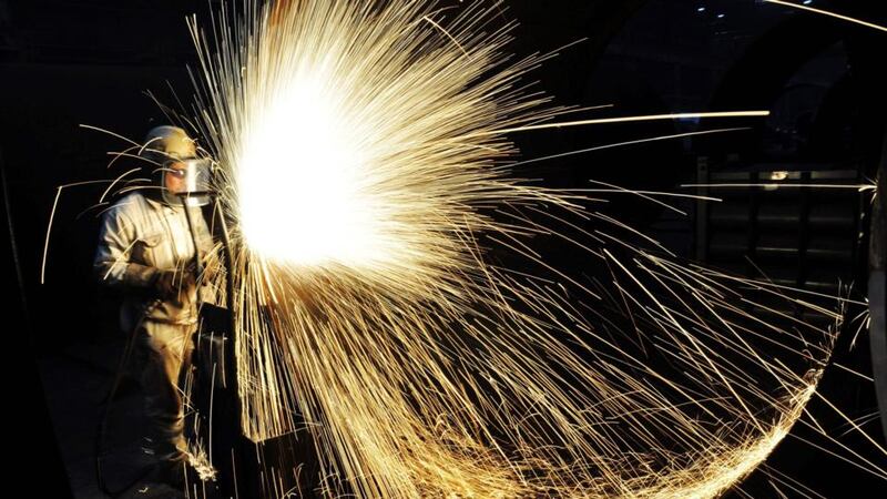 Tariff decision: a Chinese worker cuts steel; the US president’s decision could spark a trade war. Photograph: AFP