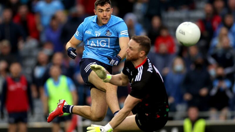 Dublin’s Colm Basquel shots wide under pressure from Mayo goalkeeper Rob Hennelly. Photograph: James Crombie/Inpho