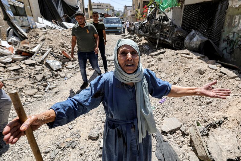 An elderly woman reacts as she stands by the rubble of broken pavement along an alley in Jenin in the occupied West Bank in July after the Israeli army declared the end of a two-day military operation in the area. Twelve Palestinians and one Israeli soldier were killed over the two days. Photograph: Jaafar AshitiyehAFP via Getty Images