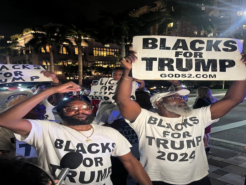 Michael 'the Blackman' (left), of Blacks for Trump, outside the Palm Beach County Convention Centre during Donald Trump's election-watch party