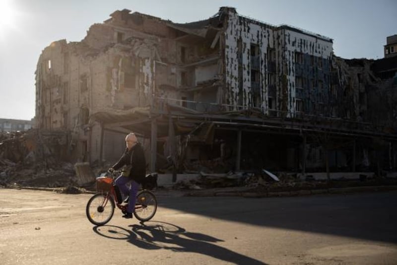 A local resident cycles past destroyed shop and restaurant in the town of Pokrovsk, in Ukraine's Donetsk region, on Tuesday. Photograph: Florent Vergnes/AFP via Getty Images