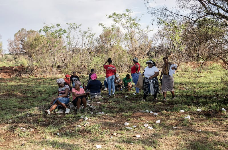 Relatives of miners and community members wait at a Stilfontein mine shaft where an estimated 4,000 illegal miners are trapped. Photograph: AP