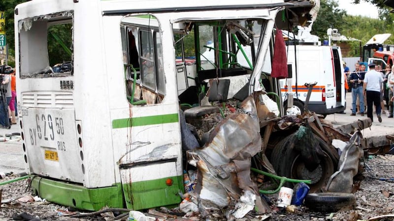 The wreckage of a bus is seen as members of the emergency services and police work at the scene of a collision between the bus and a truck outside Moscow July 13, 2013. Seventeen people were killed and many more injured on Saturday when a truck plowed into a bus in a Moscow suburb, breaking it in two, Russia’s emergency ministry said. REUTERS/Sergei Karpukhin