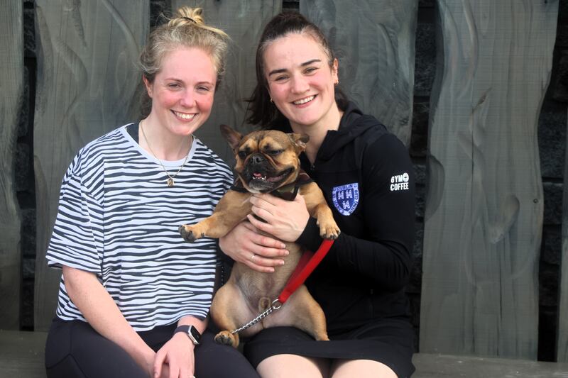 Olympic champion Kellie Harrington with her wife, Mandy Loughlin, and their rescue French-cross Gus at the opening of the pet memorial garden in the Dublin Mountains. Photograph: Ronan McGreevy