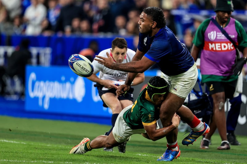 France's Peato Mauvaka offloads as he is tackled by South Africa's Kurt-Lee Arendse during the 2023 Rugby World Cup quarter-final at the Stade de France. Photograph: Dan Sheridan/Inpho