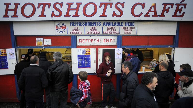 Aldershot fans grab a burger before kick-off at The Recreation Ground. Photograph: Charlie Crowhurst/Getty Images