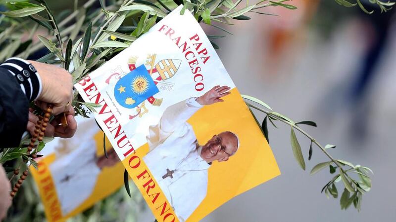 A worshipper  holds a flag with a picture of Pope Francis in Saint Peter’s Square at the Vatican. Photograph: Alessandro Bianchi/Reuters