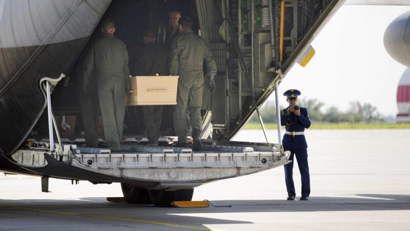 Soldiers load a coffin with the remains of a victim of the Malaysia Airlines flight MH17 to a military plane during a ceremony on the airport of Kharkiv, Ukraine, Photograph: Evert- Jan Daniels/EPA