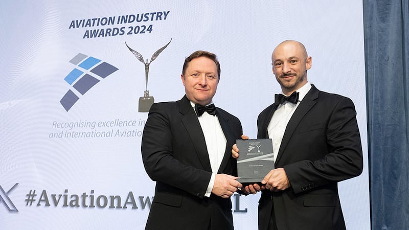 Wayne Tyrell, awards judge, presents the aviation export award to Guillaume Riggi, Aterim