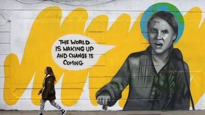 A pedestrian walks past a mural of climate activist Greta Thunberg in Smithfield, Dublin. Photograph: Laura Hutton