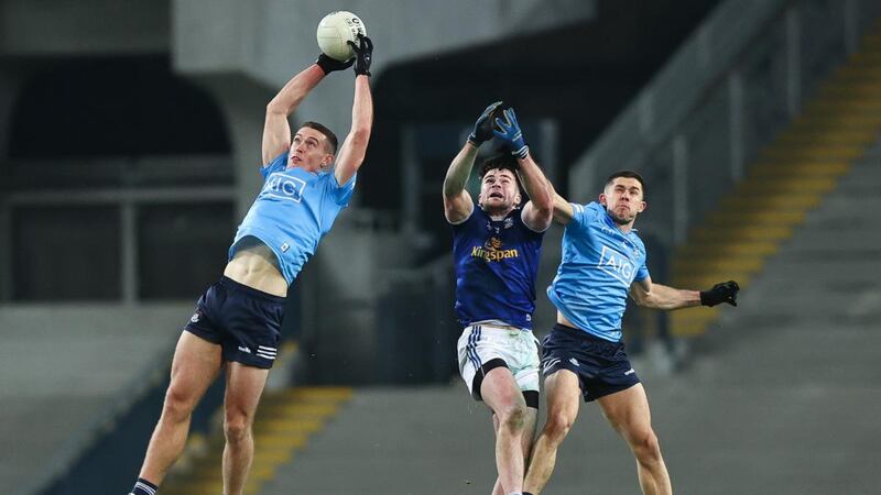 Dublin’s Brian Fenton claims the ball as team-mate Davy Byrne and  Pádraig Faulkner of Cavan also contest during the  All-Ireland SFC semi-final at Croke Park. Photograph: Tommy Dickson/Inpho