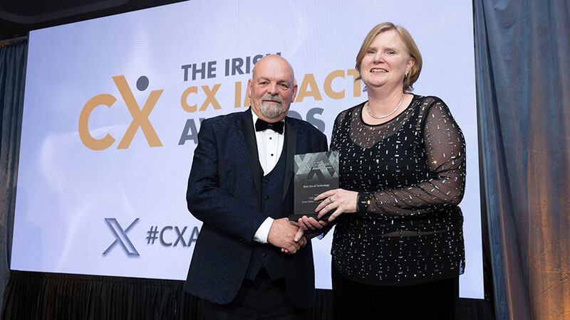 Eddie Stack, awards judge, presents the best use of technology award to Carmel O'Connor, ESB Networks