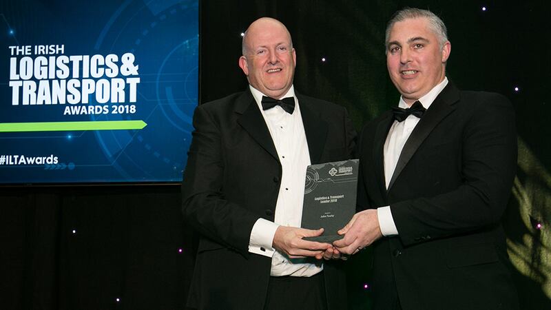 Aidan Flynn, General Manager, FTA Ireland presents the Logistics & Transport Leader 2018 award to John Tuohy