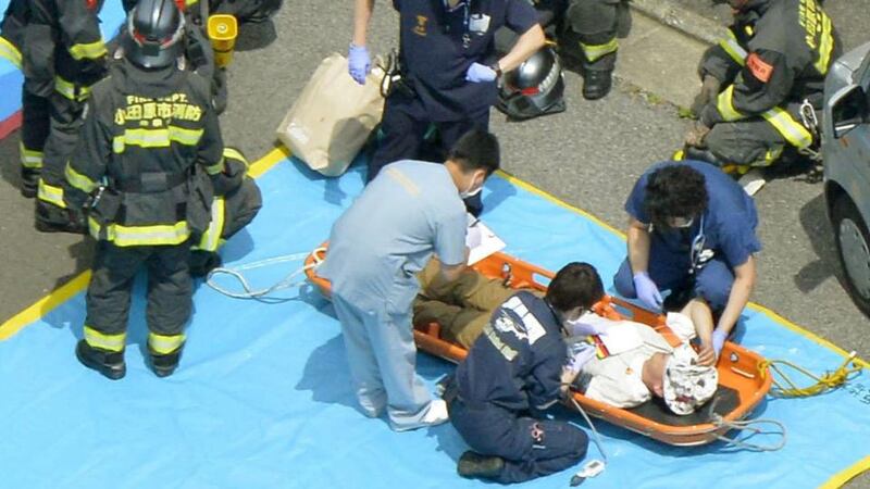 A passenger receives medical treatment from rescue workers after their Shinkansen bullet train made an emergency stop in Odawara, south of Tokyo on Tuesday. Photograph: Reuters/Kyodo