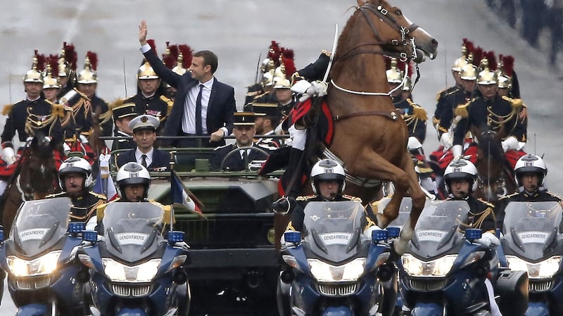 A horse rears as French president Emmanuel Macron parades in a car on the Champs Élysées after his formal inauguration ceremony in 2017. Photograph: Michel Euler/AFP/Getty