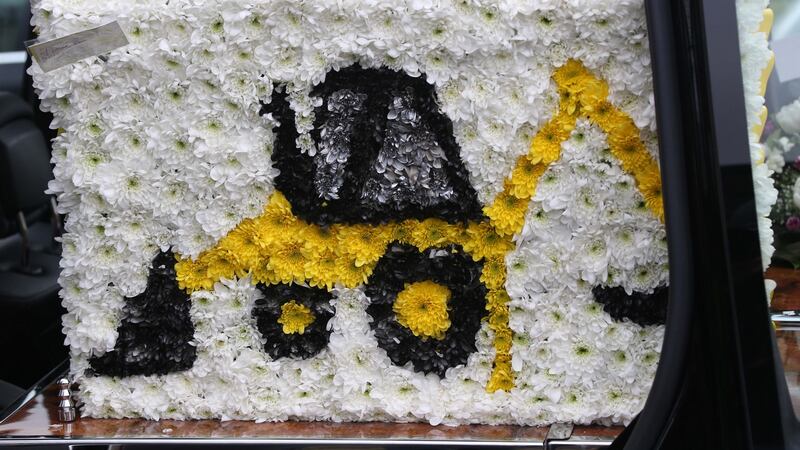 Floral tributes to Kenneth: One of the offertory gifts was a photograph his son driving his digger. Photograph: Colin Keegan/Collins