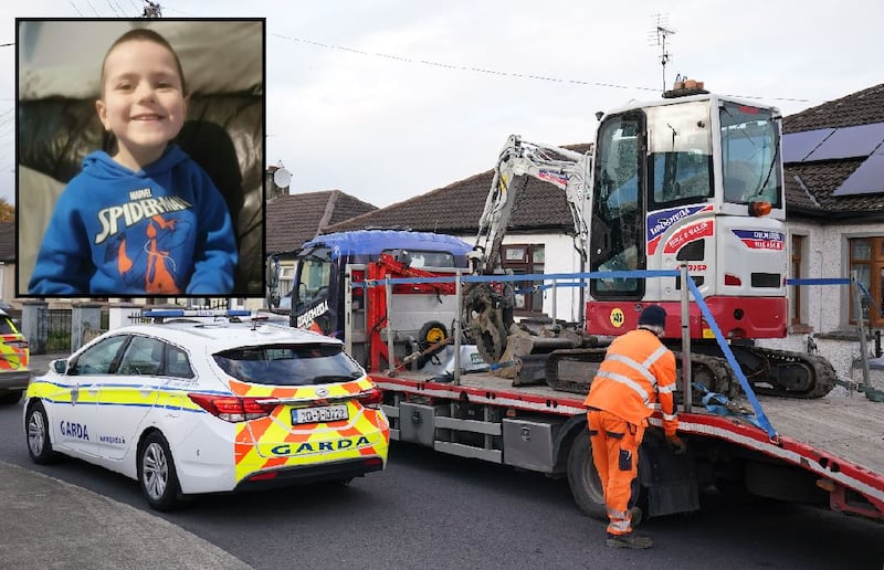 A mechanical digger used by gardaí in a search in Dundalk, Co Louth, for missing boy Kyran Durnin (inset) leaves the area on Thursday. Photograph: Brian Lawless/PA Wire