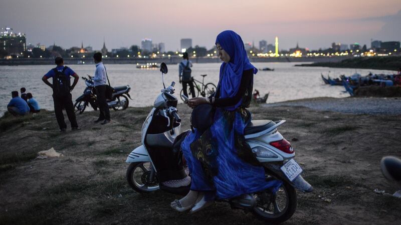 A woman waits for a ferry to take her across the Tonle Sap river in March 2017. Photograph: Lauren Crothers