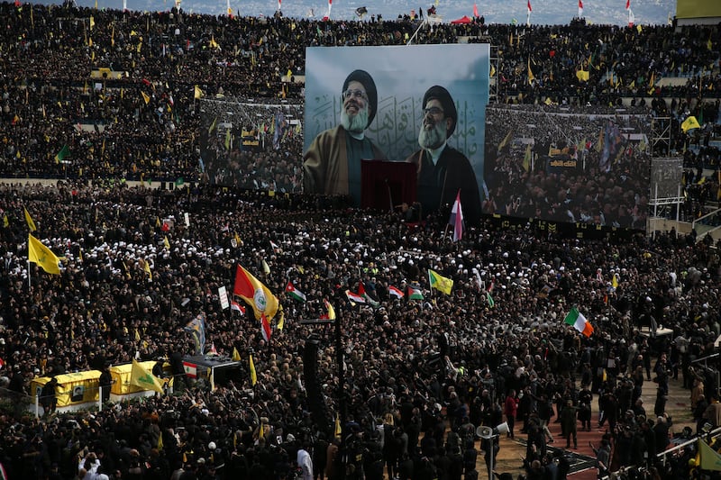 An Irish flag is visible as the coffins of Hassan Nasrallah and Hashem Safieddine approach the stage during Sunday's funeral. Photograph: Sally Hayden