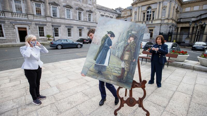 Senator Mark Daly carries the painting “Her Surrender” by Sinéad Guckian  from the Dáil plinth with    Senator Regina Doherty (left)   and Senator Fiona O’Loughlin looking on. Photo: Tom Honan/The Irish Times.