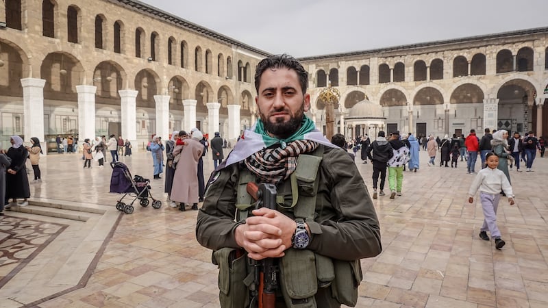 Rebel fighter Louy Gabso (26), who came to Damascus's Umayyad Mosque to celebrate the Assad regime's ousting