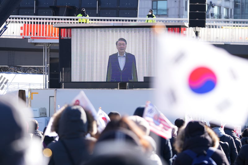 A screen displays footage of impeached South Korean President Yoon Suk Yeol as supporters stage a rally to oppose his impeachment near the presidential residence in Seoul. Photograph: Lee Jin-man/AP