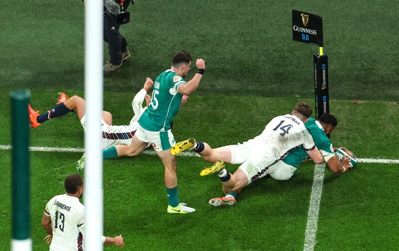 Ireland’s Bundee Aki shows his strength to power through and score his second try despite Tommy Freeman of England, levelling the game with England. Photograph: Inpho