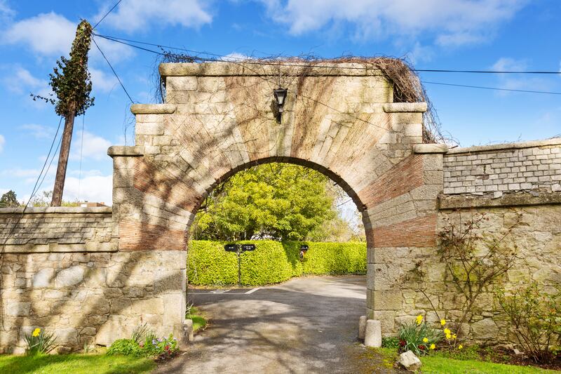 The house is accessed by an archway