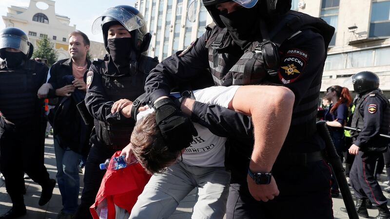 Law enforcement officers detain a participant in a rally calling for opposition candidates to be registered for elections to Moscow’s regional parliament. Photograph: Shamil Zhumatov/Reuters