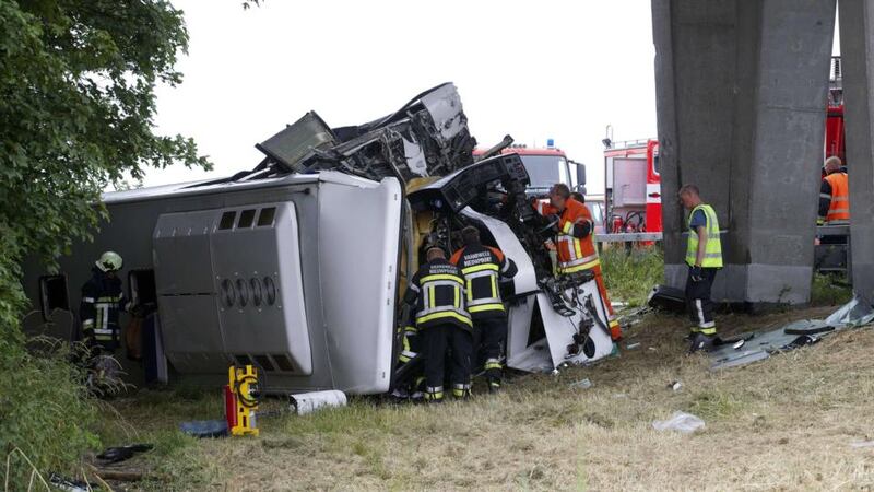 Rescue services work at the site where a bus carrying 34 schoolchildren crashed off the E40 highway in Middelkerke, Belgium. Photograph: Nicolas Maeterlink/AFP