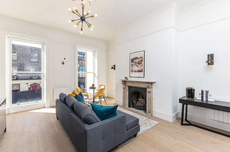 Living area with original marble fireplace in apartment two (a one-bed asking €440,000)