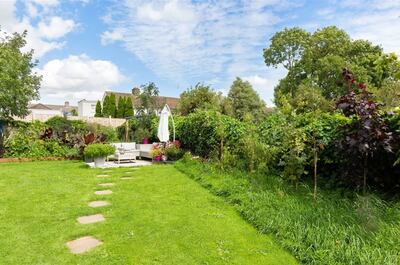 Private back garden has been well maintained with blossoming flower beds and trees around the perimeter