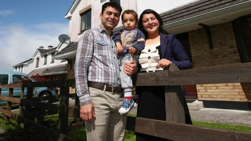 Halala and Mero Ahmadi with their son Jamil outside their home in Carrick on Shannon. They are all members of the Kurdish local community. Photograph: Brian Farrell