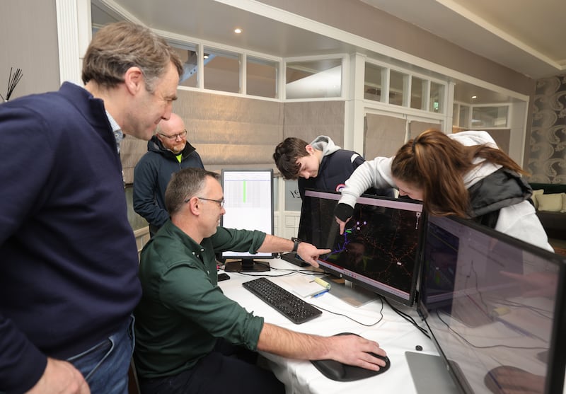 Robert Grimes and Karol Fitzgerald from ESB Networks inform members of the Walsh Family from Gortnaclohy, Ashford, Co Limerick, about the current status of repairs to electricity lines leading to their home in the hotel. Photograph: Alan Betson/The Irish Times