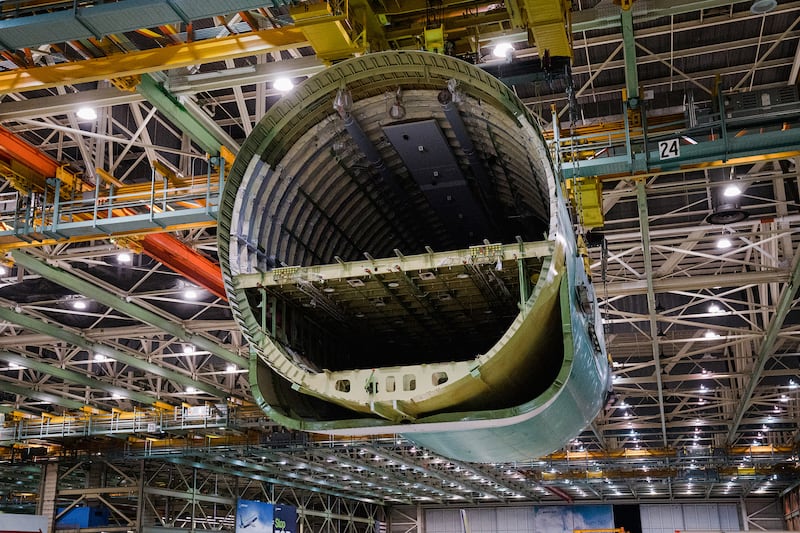 Cranes lift the rear fuselage during the final body join. Photograph: Jovelle Tamayo/The New York Times