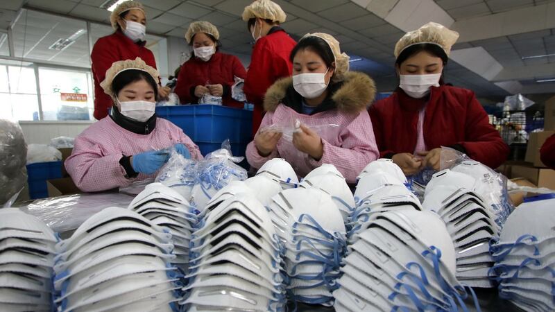 Workers manufacture protective face masks in a factory, as face mask stocks run low amid the outbreak of coronavirus, in Handan, Hebei Province, China. Photograph: EPA