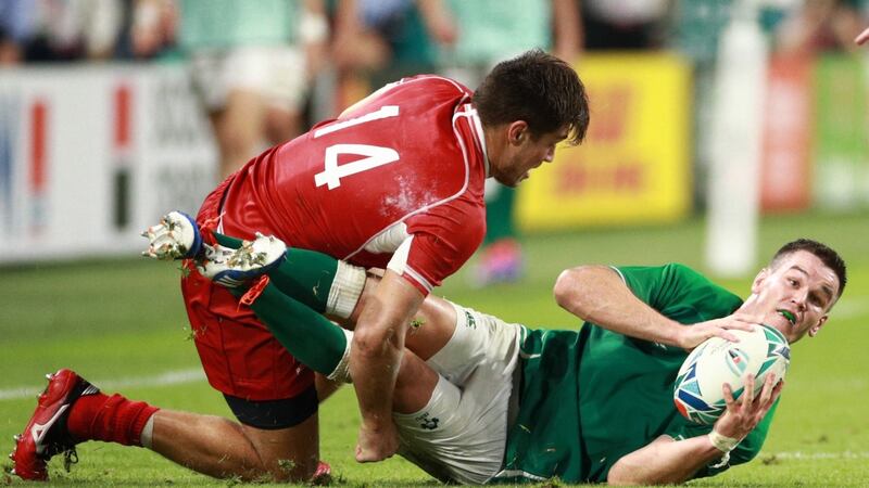 Johnny Sexton looks to offload the ball after being tackled by German Davydov. Photograph: Adam Pretty/Getty