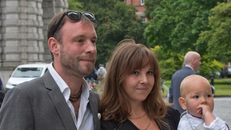 Isabella Boudard, daughter of Paulo Tullio, with her son Balthazar and husband Simon,  at Trinity College Dublin for her father’s  memorial service. Photograph: Brenda Fitzsimons/The Irish Times