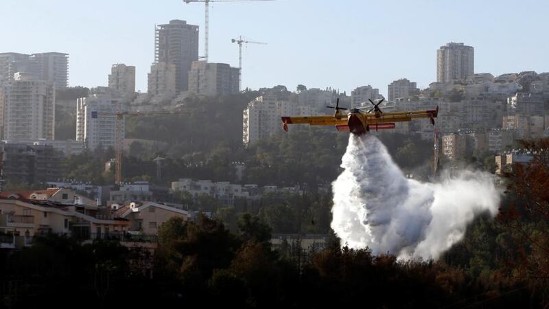 A firefighting plane drops fire-retardant over a wildfire in  the northern city of Haifa, Israel, November 25th, 2016. Photograph: Baz Ratner/Reuters