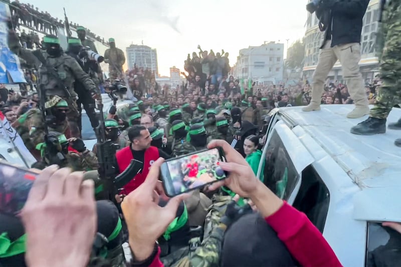 This screen grab taken from AFPTV shows one of the Israeli hostages exiting a vehicle to be handed over to the International Committee of the Red Cross (ICRC) during the hostage-prisoner exchange operation in Saraya Square in western Gaza City on Sunday. Photograph: AFPTV/AFP