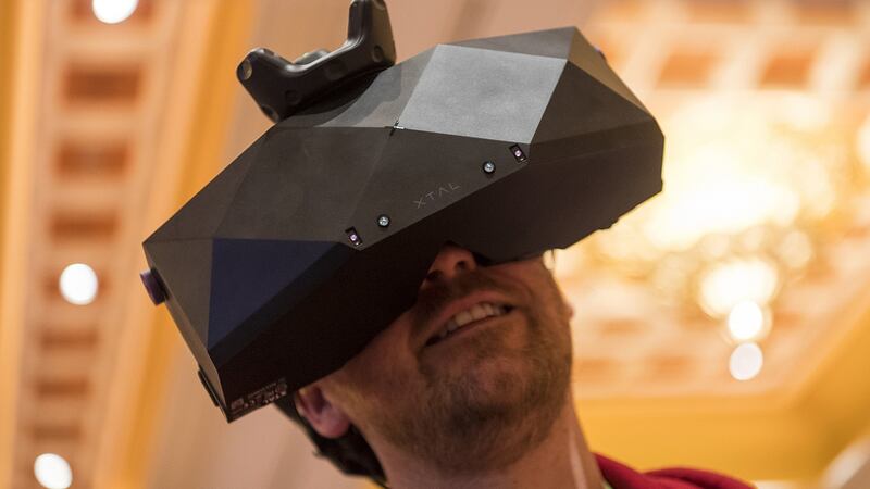 An attendee tries on a VRgineers Inc. XTAL virtual reality (  headset during the ShowStoppers event at CES 2019. Photograph: David Paul Morris/Bloomberg