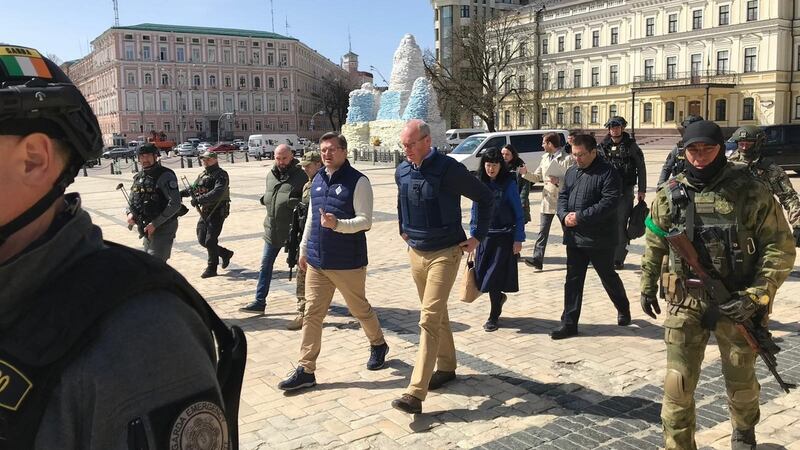 Minister for Foreign Affairs Simon Coveney and his Ukrainian counterpart Dmytro Kuleba walking with Ukranian special forces and Garda ERU to lay flowers at a memorial wall in Kyiv on Thursday. Photograph: Department of Foreign Affairs