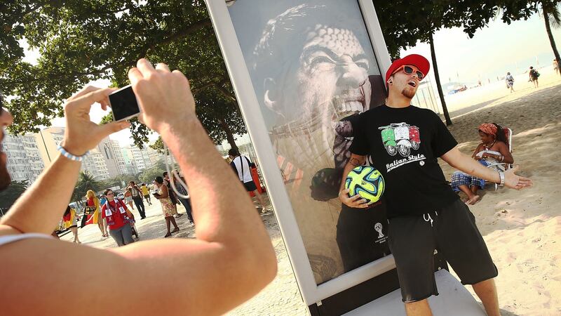 An advertisement featuring Luis Suarez on the Copacobana Beach in Rio de Janeiro. Photograph: Mario Tama/Getty