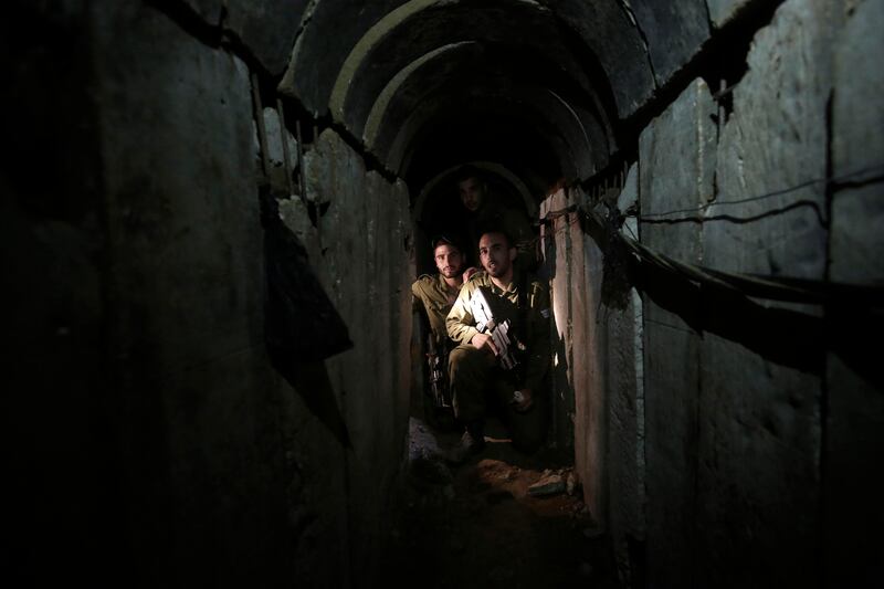 Israeli soldiers walk through a tunnel discovered near the Israel-Gaza border in 2013. Photograph: Tsafrir Abayov/AP