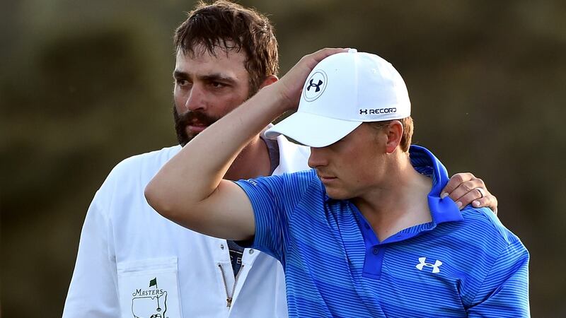 A dejected  Jordan Spieth with  caddie Michael Greller aafter finishing on the 18th green during the final round of the 2016 Masters at Augusta National. Photographer:   Harry How/Getty Images